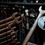 Detailed view of scattered wrenches and metal parts, showcasing an array of tools for mechanical purposes.