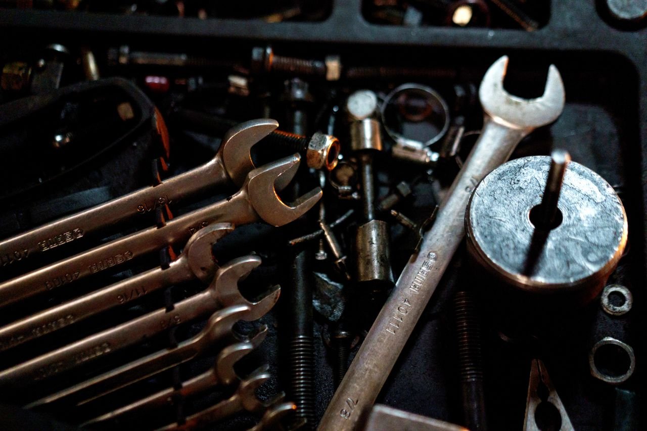 Detailed view of scattered wrenches and metal parts, showcasing an array of tools for mechanical purposes.