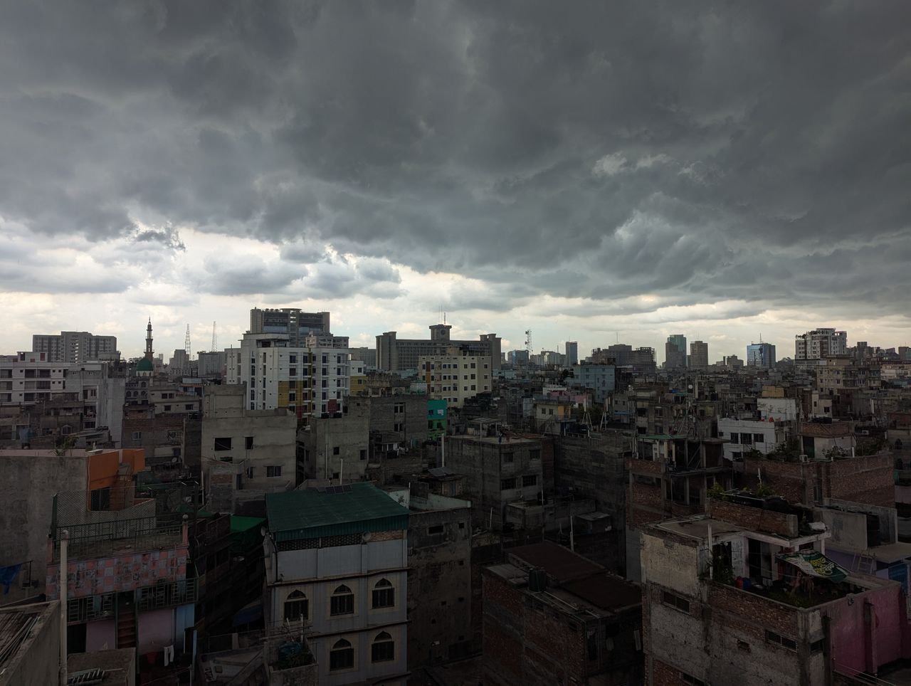 Stormy clouds loom over the bustling cityscape of Dhaka, Bangladesh.