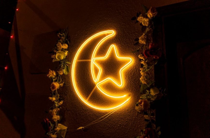 Neon crescent moon with star and floral garland, ideal for festive decor.