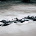 An aerial view of a structure overwhelmed by a river flood in Bern, Switzerland.